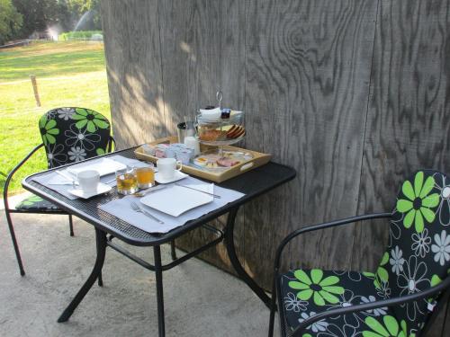 a table with a tray of food on it at Bnb Pavillon Paisible in Orsonnens