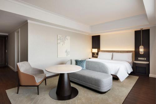 a hotel room with a bed and a table and a couch at The Westin Tokyo in Tokyo