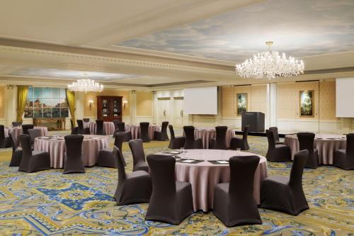 a ballroom with tables and chairs in a room with chandeliers at The Westin Tokyo in Tokyo