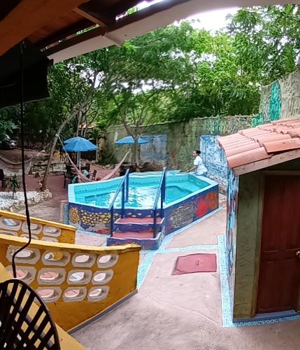 a pool in a park with a person in the background at Villa Margarita in Puerto Colombia
