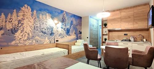 a kitchen with a large painting on the wall at Apartments KOP Konaci in Kopaonik