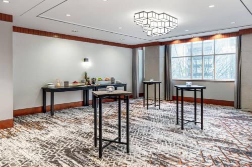 a room with three tables and a large window at Delta Hotels by Marriott Vancouver Downtown Suites in Vancouver