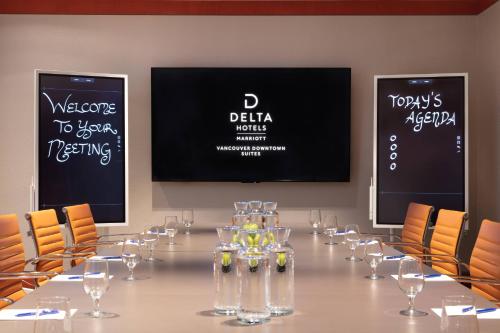 a conference room with a long table with wine glasses at Delta Hotels by Marriott Vancouver Downtown Suites in Vancouver