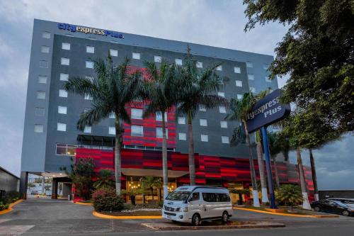 a white van parked in front of a building at City Express Plus by Marriott Guadalajara Expo in Guadalajara