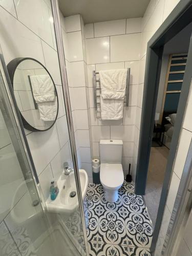 uma casa de banho com um WC, um lavatório e um espelho. em CV1 City Stays - Short & Long Term Accommodation No.6 em Coventry