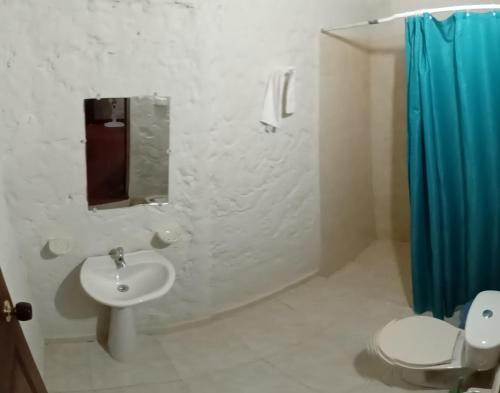 a bathroom with a sink and a toilet and a shower at Villa Margarita in Puerto Colombia