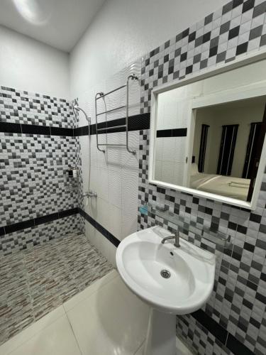 La salle de bains est pourvue d'un lavabo et d'un miroir. dans l'établissement บารอนรีสอร์ทสระแก้ว, à Sa Kaeo