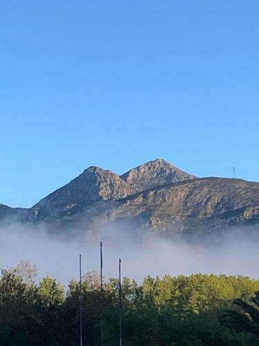 a foggy field with mountains in the background at Hotel Restaurante Benidorm 1970 in Villamayor