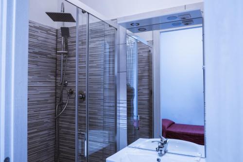bagno con doccia, lavandino e specchio di Hotel d'Este a Roma