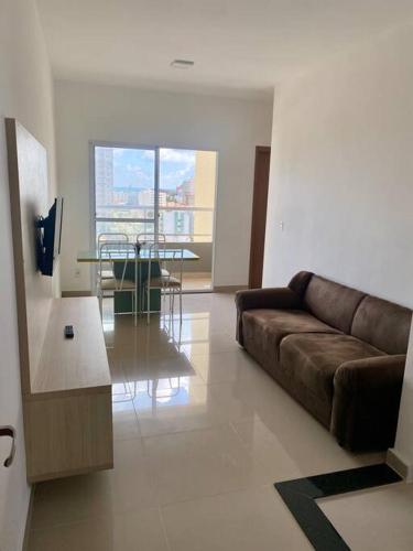 a living room with a couch and a table at Apartamento em Ponta de Campina in Cabedelo