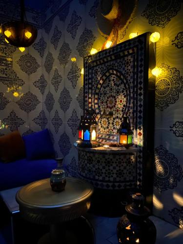 a room with a couch and a table with lights at Dar El Yacout in Rabat