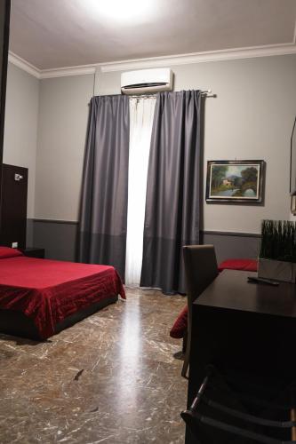 a bedroom with a red bed and a window at Hotel d'Este in Rome