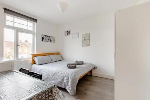 a white bedroom with a bed and a window at Double Room No,4 Edmonton Green, London N9 in London