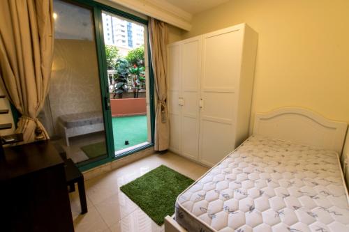 um quarto com uma cama e uma grande janela em Budget Rooms With Private Bathroom for 'girls' only in Dubai, Marina em Dubai