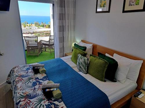 a bedroom with a bed with a view of the ocean at Ocean View Penthouse in Playa de las Americas