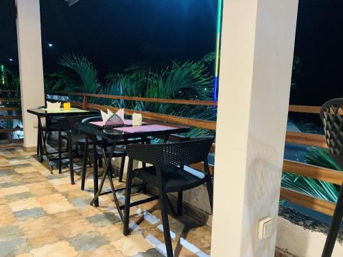 a row of tables and chairs on a patio at Namaste hotel & restaurant in Libreville