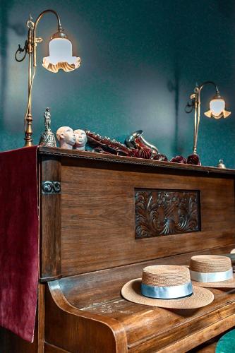 a table with two hats on top of it at VASILIKON Hotel 1888 the past is present HISTORICAL PRESERVATION MONUMENT in Kalamata