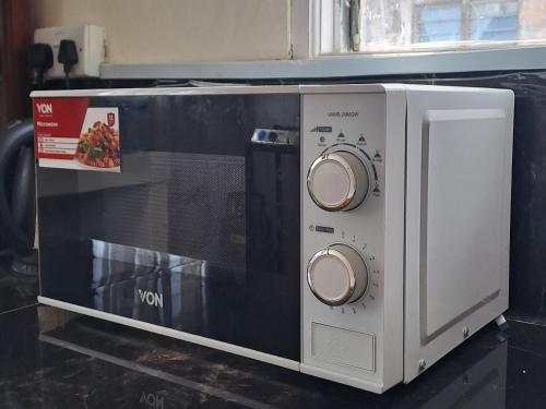 a microwave oven sitting on top of a counter at Zahra Homes in Mombasa