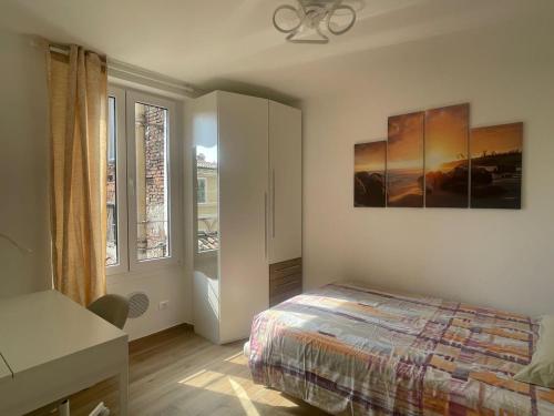 a bedroom with a bed and a painting on the wall at CAIROLI14 in Brescia