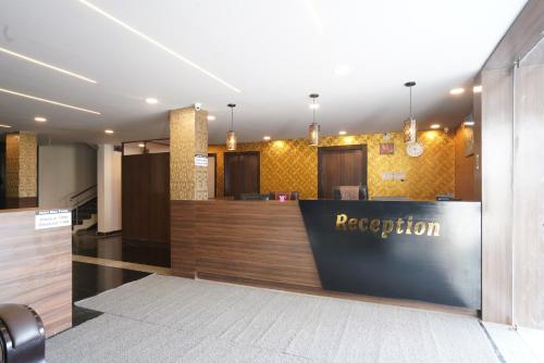 a reception area of a hotel lobby with a reception desk at Hotel Blue Petals in Shamshabad
