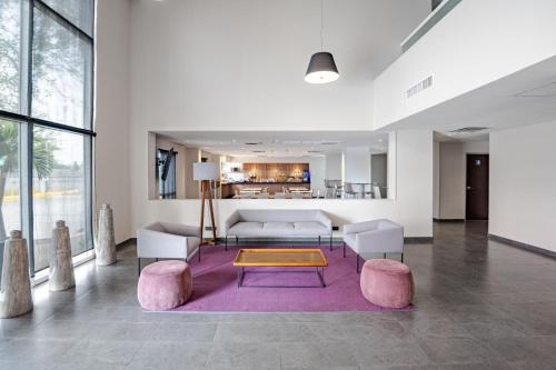 錫勞的住宿－思勞機場城市快捷酒店，客厅配有沙发和桌子