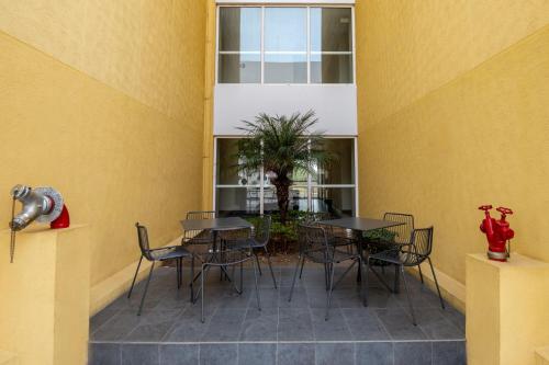a patio with tables and chairs in a building at City Express by Marriott Silao Aeropuerto in Silao