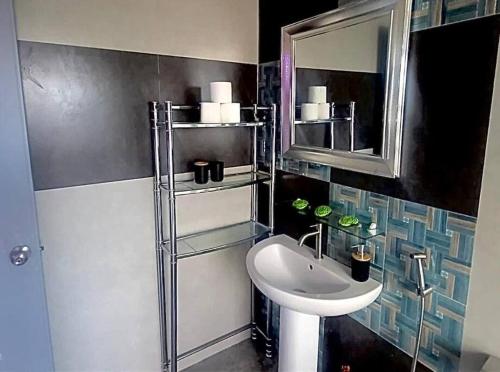 uma casa de banho com um lavatório e um espelho em Kandi Modern 1BR, king bed. Wi-Fi, housekeeping! em Angeles
