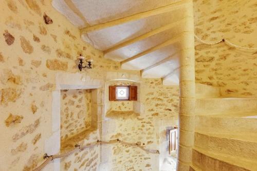 a room with a clock on the wall at 14th Century Priory in Pressigny in Pressigny