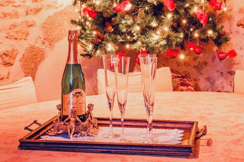 a bottle of champagne and glasses on a tray at 14th Century Priory in Pressigny in Pressigny