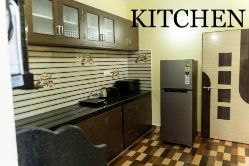 a kitchen with a refrigerator next to a counter at Seacastle luxury apartments in Consua