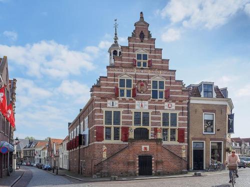 a man riding a bike in front of a building at De Kapelle in Oudewater in Oudewater