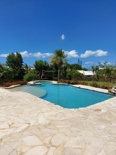 a swimming pool in a resort with blue water at Villa Louise in Sainte-Rose