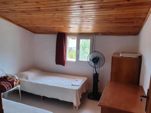 a room with two beds and a window at Bahçeli çift katlı villa sahile 300 metre in Kusadası