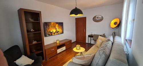 a living room with a couch and a fireplace at Tatra diamond appartement 70m2 v centre s parkovanim zadarmo in Poprad
