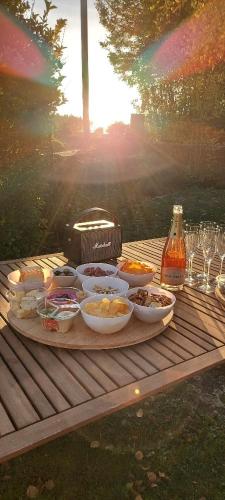 a tray of food on a wooden table with drinks at La Tour du Boueix in Préveranges