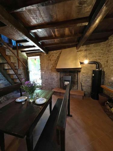 a living room with a table and a fireplace at Tuscany Escape in Borgo a Mozzano