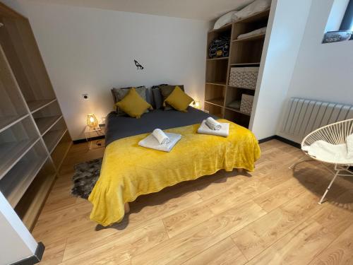 a bedroom with a bed with two towels on it at Appartement - La Meute in Magland