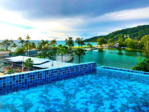 a swimming pool with a view of a river at Phoenix Hotel Karon Beach in Karon Beach