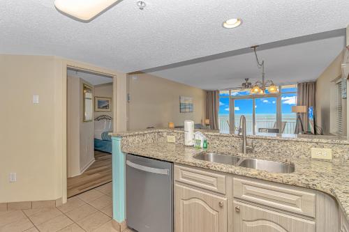 a kitchen with a sink and a view of the ocean at Atlantica 757 in Myrtle Beach