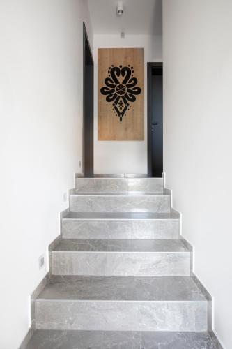 a set of stairs with a painting on the wall at Villa Gorczański Zakątek Agroturystyka in Konina