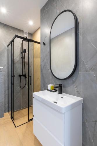 a bathroom with a white sink and a mirror at Villa Gorczański Zakątek Agroturystyka in Konina