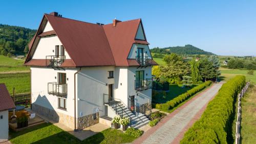 une vue aérienne sur une maison avec un toit rouge dans l'établissement Villa Gorczański Zakątek, à Konina