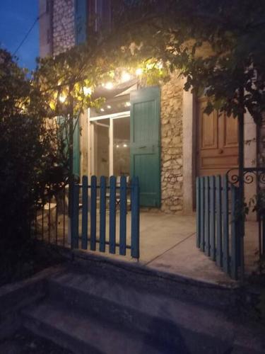 a fence in front of a house with a door at Maison de vacances dans le Diois au pied du Vercors avec 2 chambres pour 6 personnes in Menglon
