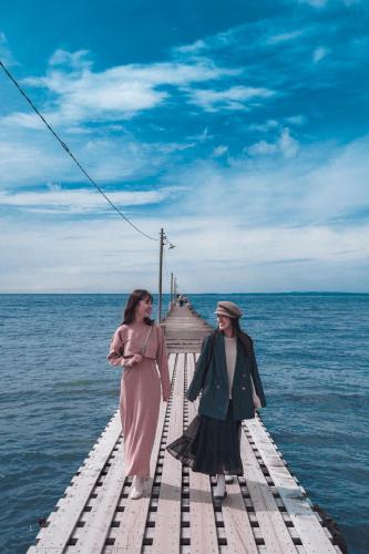 two women standing on a dock in the water at UMInoTERRACE in Minamiboso