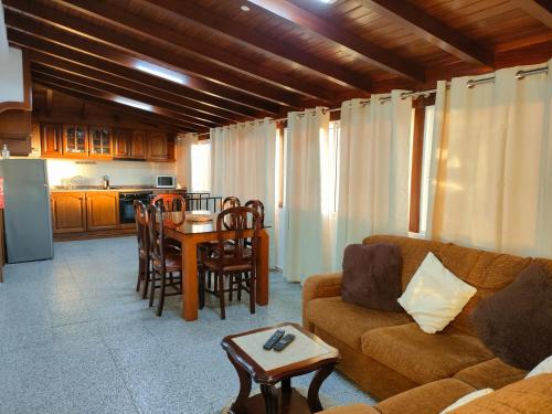 a living room with a couch and a table at Rochinha House in Funchal