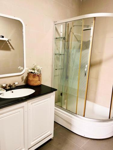 a bathroom with a glass shower and a sink at LaLa Villa Hue in Hue