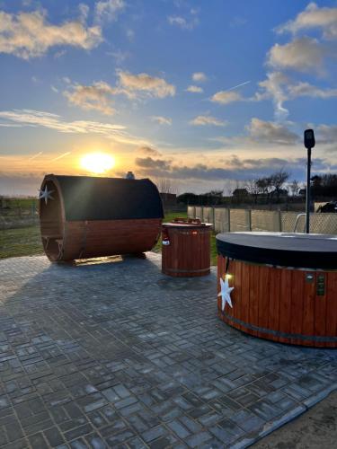 a large wooden boat sitting next to three trash cans at Słoneczny Horyzont in Zastań