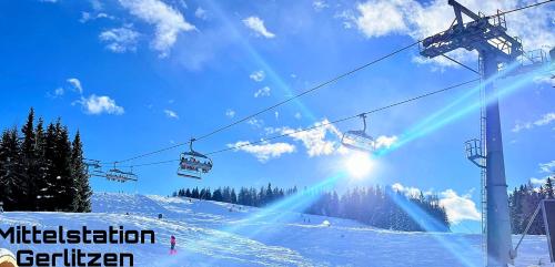 a ski lift on a snow covered ski slope at Sweet Mountain Home in Bad Bleiberg