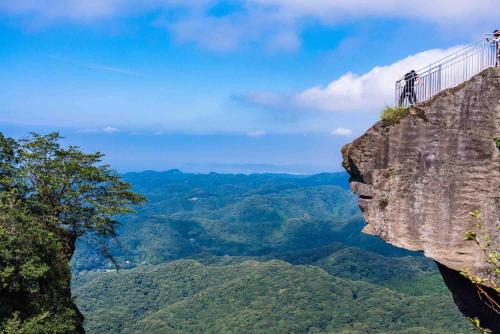 people on a suspension bridge on a cliff in the mountains at UMInoTERRACE in Minamiboso