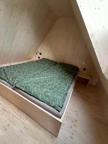 a bed in the middle of a small room at Penzion a Restaurace Pod Sjezdovkou in Čenkovice